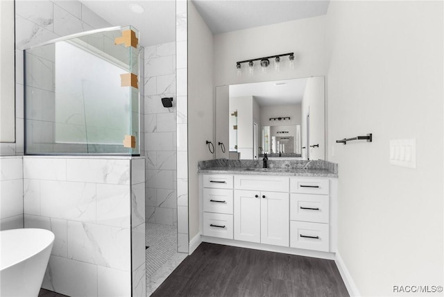 bathroom with vanity, wood-type flooring, and shower with separate bathtub