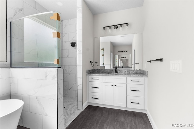 bathroom featuring shower with separate bathtub, wood-type flooring, and vanity