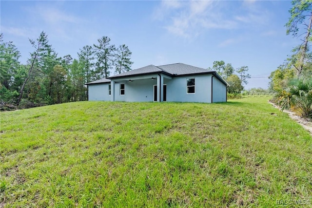 back of house featuring a yard