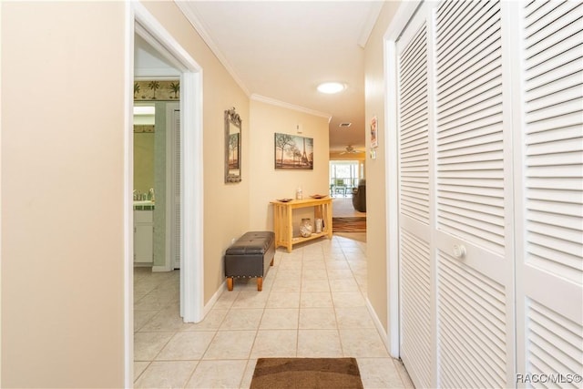 hallway with light tile patterned floors and ornamental molding