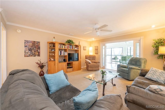 carpeted living room with ornamental molding and ceiling fan