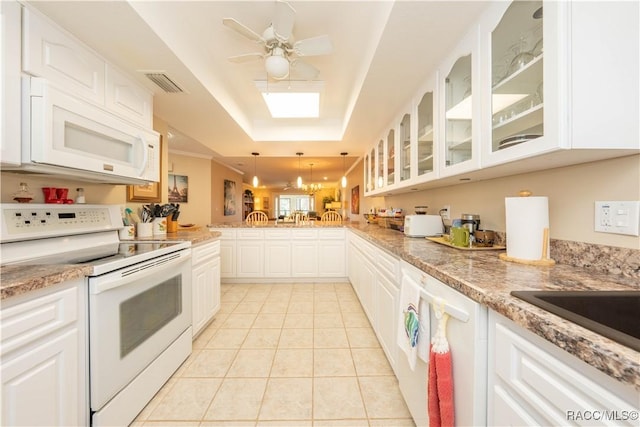 kitchen with white cabinetry, white appliances, a raised ceiling, and pendant lighting