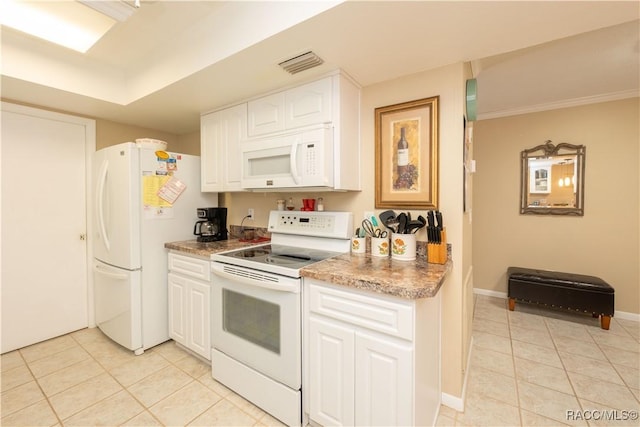 kitchen with white appliances, light tile patterned floors, and white cabinets