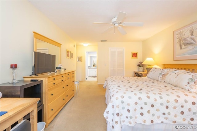 carpeted bedroom featuring ceiling fan and a closet