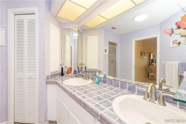 bathroom featuring vanity and a shower with door