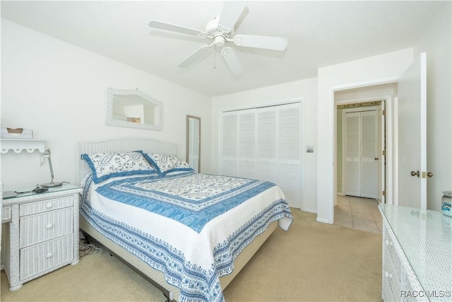 carpeted bedroom featuring ceiling fan and a closet