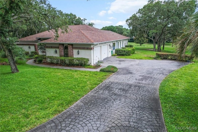 330 E Ireland Ct, Hernando, FL 34442 - single story home featuring asphalt driveway, an attached garage, a front yard, and stucco siding