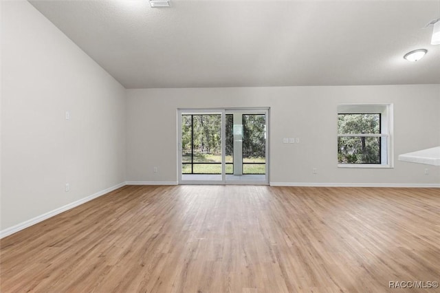 6613 N Bedstrow Blvd, Dunnellon, FL 34434 - unfurnished living room featuring healthy amount of natural light and light wood-style flooring