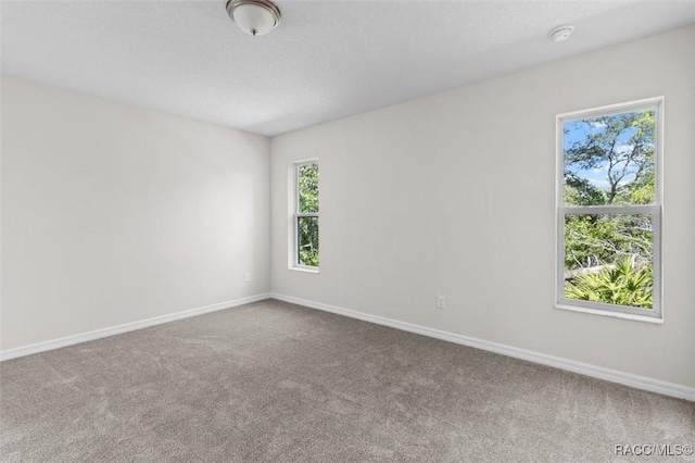 6613 N Bedstrow Blvd, Dunnellon, FL 34434 - carpeted empty room with a smoke detector and baseboards