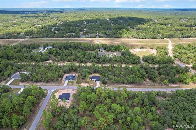 6613 N Bedstrow Blvd, Dunnellon, FL 34434 - aerial view of property and surrounding area featuring a heavily wooded area