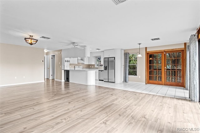 unfurnished living room with ceiling fan and light hardwood / wood-style floors