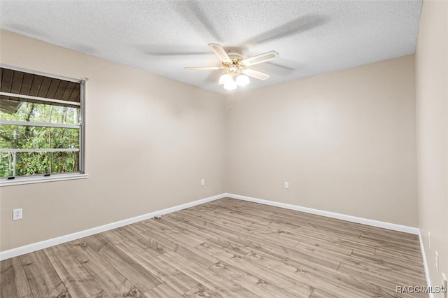 unfurnished room featuring ceiling fan, light wood-type flooring, and a textured ceiling