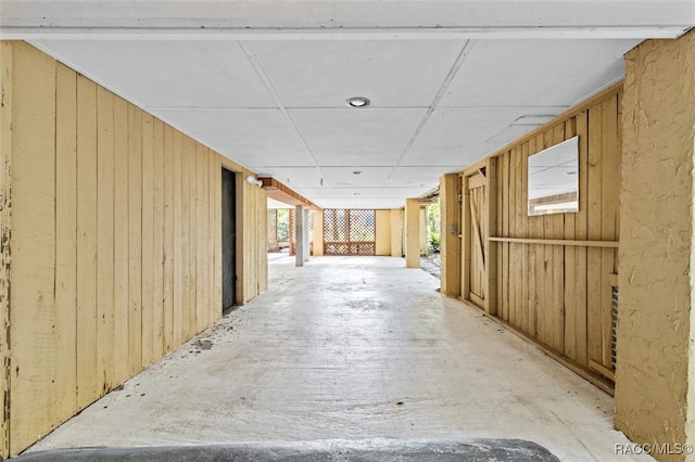 corridor featuring wooden walls