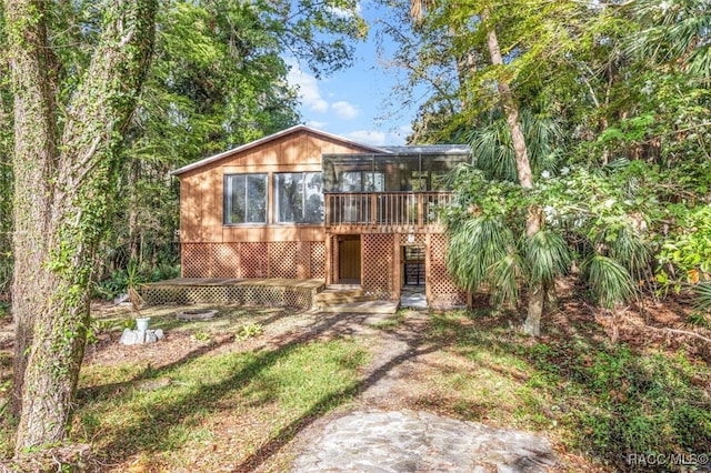 view of front facade featuring a sunroom and a deck