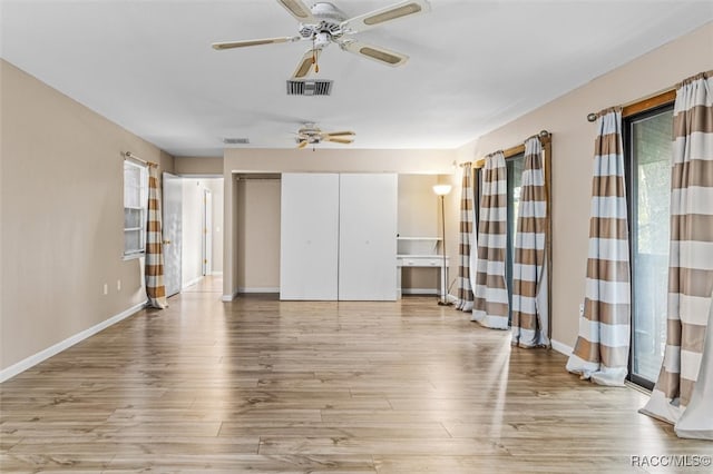 unfurnished room featuring ceiling fan and light hardwood / wood-style floors