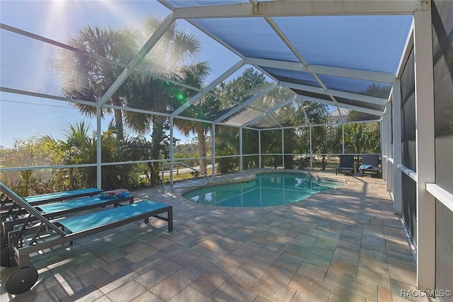 view of swimming pool featuring a patio and glass enclosure