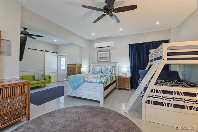 bedroom featuring ceiling fan, a barn door, and a wall mounted AC