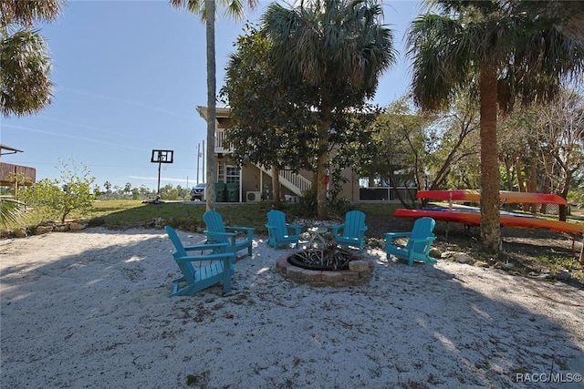 view of yard with a fire pit