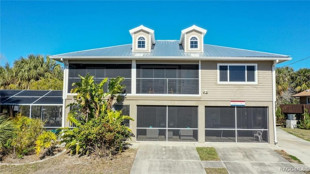 rear view of property with glass enclosure