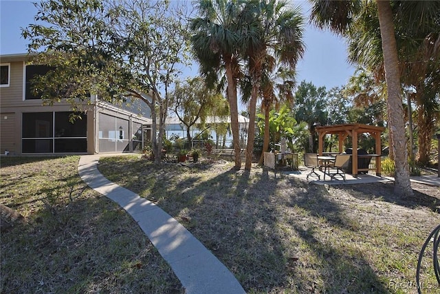 view of yard featuring a gazebo and a sunroom