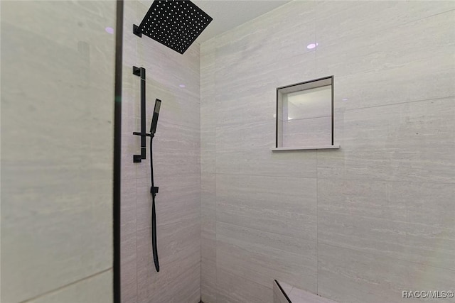 bathroom with tiled shower