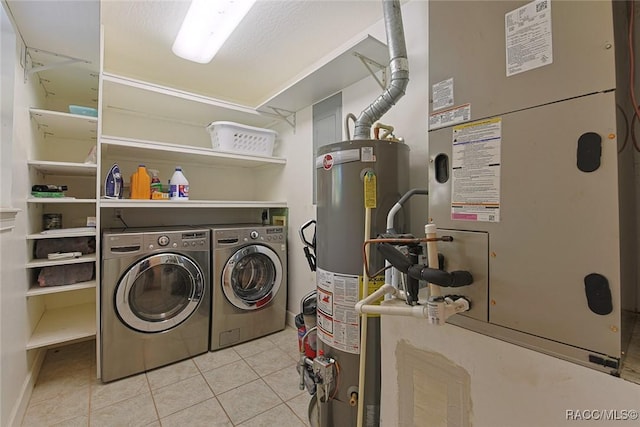 washroom featuring light tile patterned flooring, separate washer and dryer, heating unit, and gas water heater