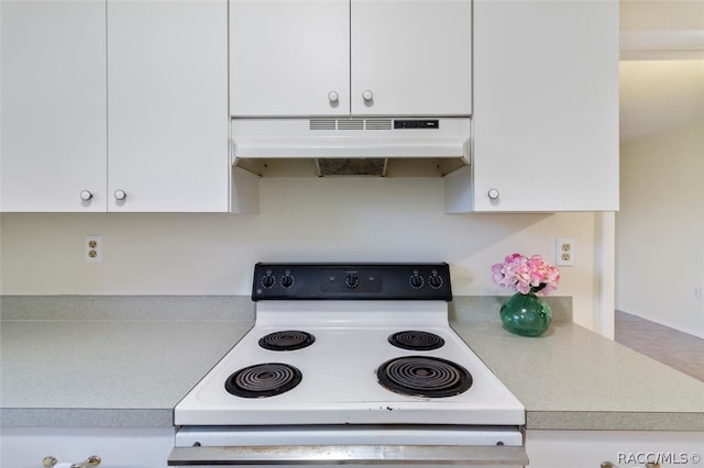 kitchen featuring white cabinetry and white range with electric stovetop