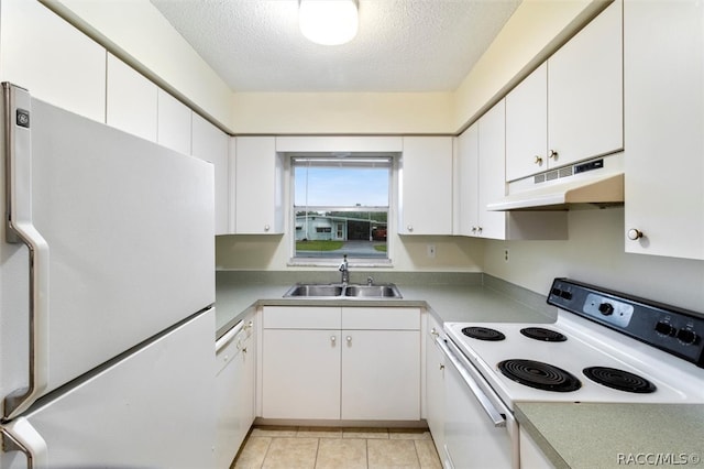 kitchen with white appliances, sink, light tile patterned floors, a textured ceiling, and white cabinetry