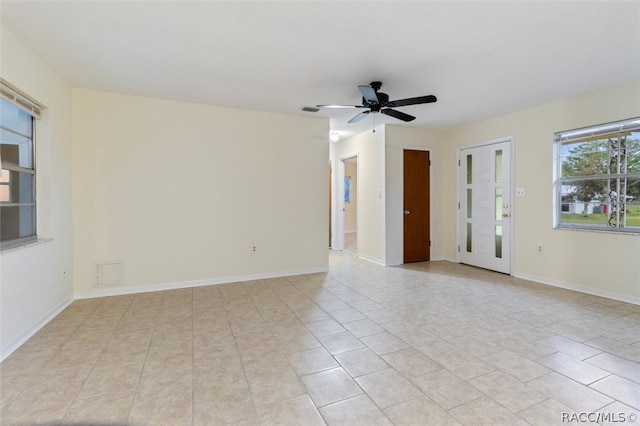 spare room featuring ceiling fan and light tile patterned floors