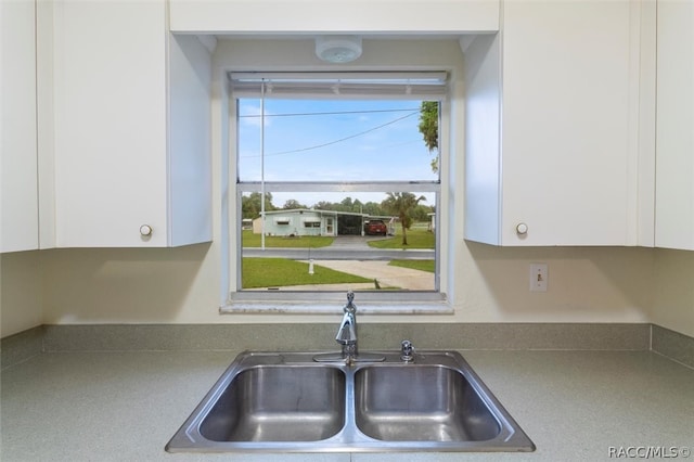 kitchen featuring white cabinetry and sink