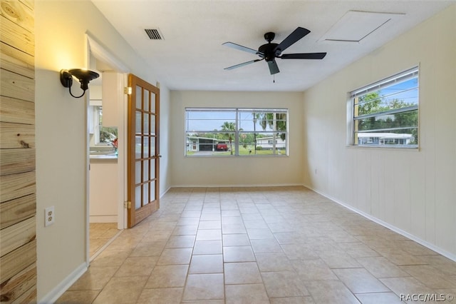 spare room with light tile patterned floors and ceiling fan