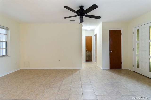 tiled empty room with ceiling fan