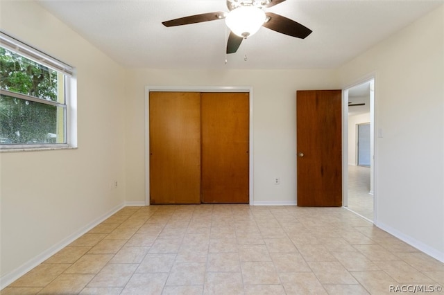 unfurnished bedroom featuring ceiling fan, a closet, and light tile patterned floors