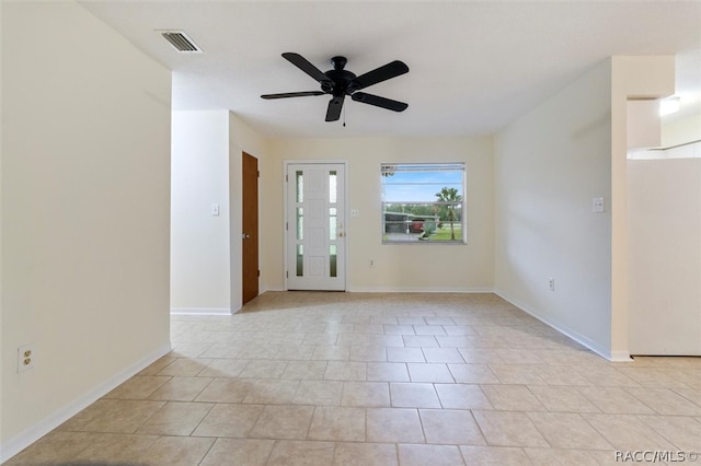 tiled empty room with ceiling fan