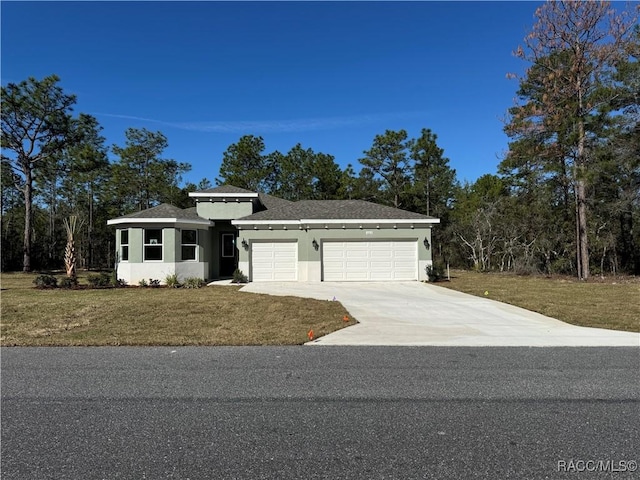 view of front facade featuring a garage, a front yard, driveway, and stucco siding