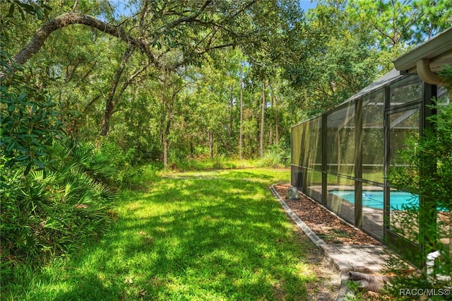 view of yard with a lanai and an outdoor pool