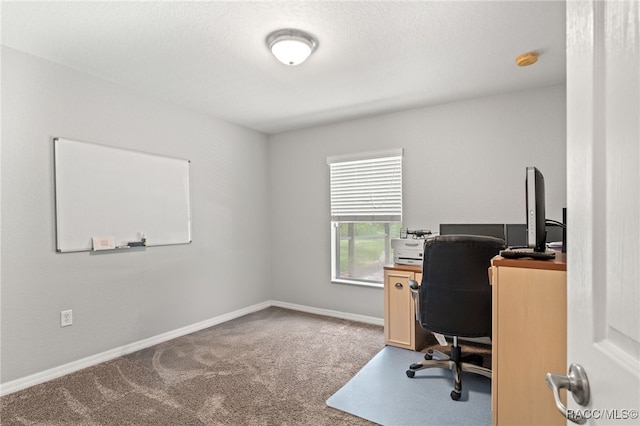 office area with a textured ceiling, carpet, and baseboards