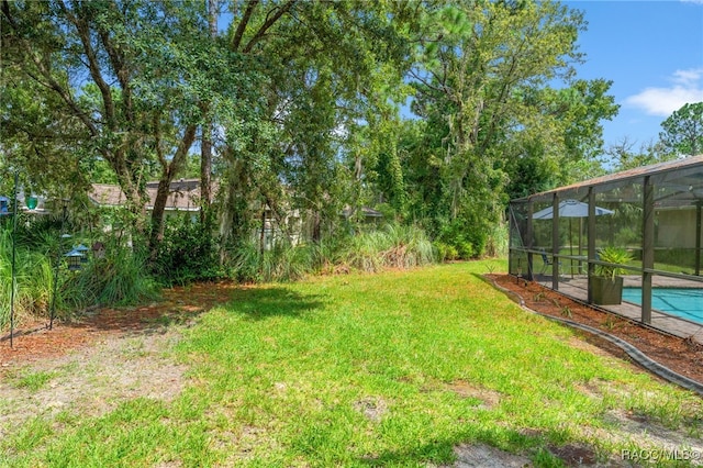 view of yard featuring a lanai and an outdoor pool