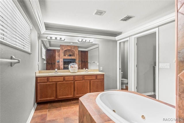 full bath featuring double vanity, visible vents, toilet, a sink, and a tub with jets