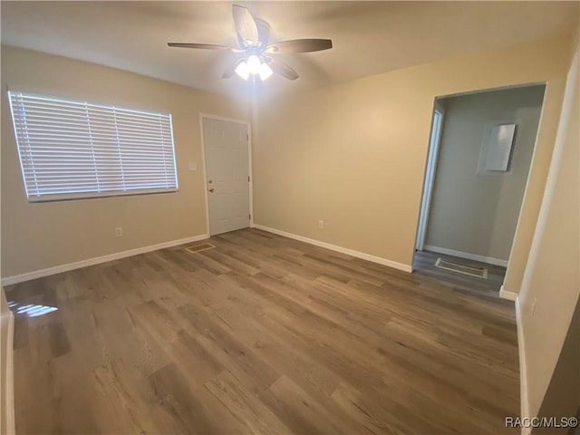 spare room with hardwood / wood-style flooring and ceiling fan