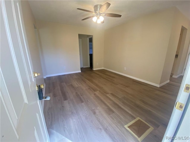 unfurnished room with ceiling fan and hardwood / wood-style flooring