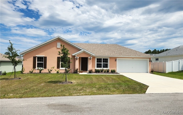 single story home featuring a garage and a front lawn