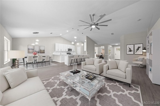 living room featuring dark hardwood / wood-style floors, ceiling fan, lofted ceiling, and sink