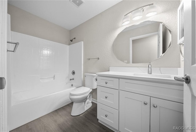 full bathroom with vanity, wood-type flooring, bathtub / shower combination, and toilet