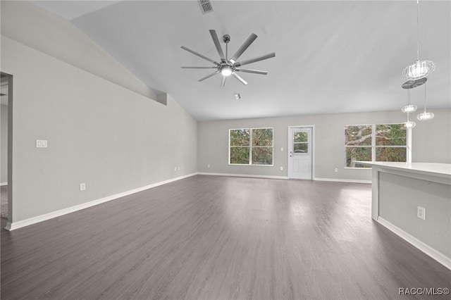 unfurnished living room featuring ceiling fan with notable chandelier, dark hardwood / wood-style floors, and lofted ceiling