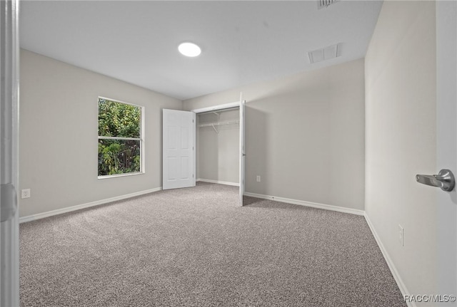 unfurnished bedroom featuring carpet flooring and a closet