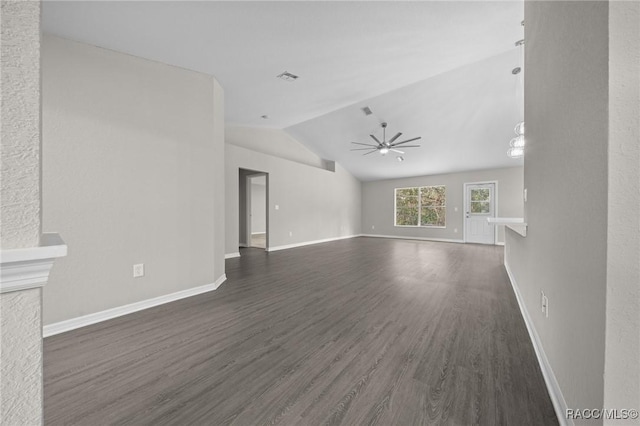 unfurnished living room featuring ceiling fan, dark hardwood / wood-style flooring, and vaulted ceiling