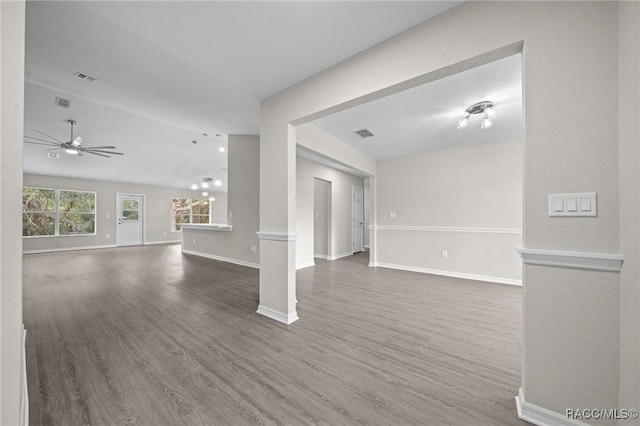 unfurnished living room with dark hardwood / wood-style floors, ceiling fan, and lofted ceiling