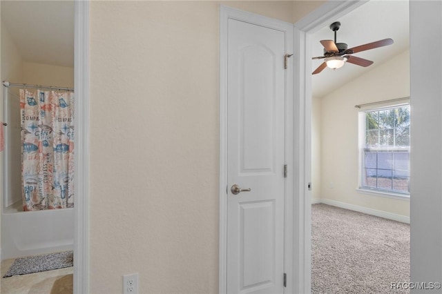 bathroom featuring ceiling fan and vaulted ceiling