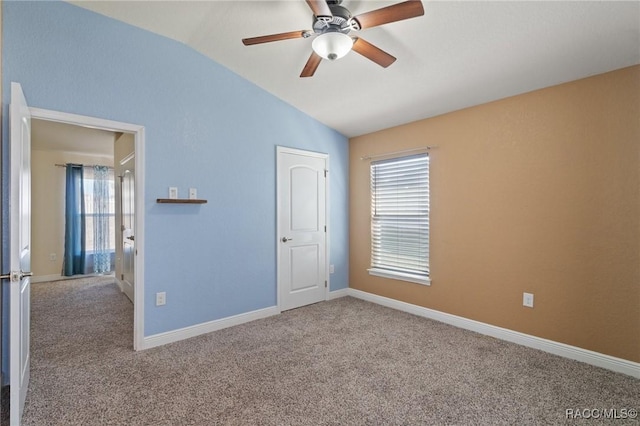 unfurnished bedroom with vaulted ceiling, carpet flooring, and ceiling fan